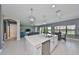 Modern kitchen island with sink and stainless steel dishwasher adjacent to the open living area at 11909 Climbing Fern Ave, Riverview, FL 33579