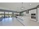 Spacious kitchen with island, stainless steel appliances and large sliding glass doors with a view at 11909 Climbing Fern Ave, Riverview, FL 33579