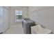 Laundry room with modern washer and dryer, utility sink, storage shelving, and window at 11909 Climbing Fern Ave, Riverview, FL 33579