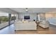 Bright living room has hardwood floors, modern furniture, gray walls, ceiling fan, and great natural light at 11909 Climbing Fern Ave, Riverview, FL 33579