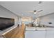 Open-concept living space with hardwood floors, comfortable sofa, and a view leading to the second floor at 11909 Climbing Fern Ave, Riverview, FL 33579