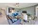 Open-concept living room featuring neutral walls, modern furnishings, and lots of natural light at 11909 Climbing Fern Ave, Riverview, FL 33579