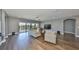 Spacious living room features hardwood floors, neutral walls, comfortable seating, and bright natural light at 11909 Climbing Fern Ave, Riverview, FL 33579