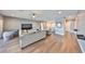 Large living room offers hardwood floors, comfortable sofa, neutral walls, and lots of room for activities at 11909 Climbing Fern Ave, Riverview, FL 33579