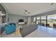 Open living room with a fan, tile flooring, overlooking the water through sliding glass doors at 11909 Climbing Fern Ave, Riverview, FL 33579