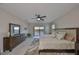 Large main bedroom with ceiling fan, balcony access and lake view at 11909 Climbing Fern Ave, Riverview, FL 33579