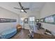 Office with hardwood floors, many windows, ceiling fan, leather chair, and desk setup at 11909 Climbing Fern Ave, Riverview, FL 33579