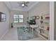 Well-lit home office featuring a ceiling fan, modern shelving, and a comfortable workspace at 11909 Climbing Fern Ave, Riverview, FL 33579