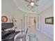 Bright office with glass doors leading to the foyer, modern shelving, and neutral tile flooring at 11909 Climbing Fern Ave, Riverview, FL 33579