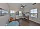 Office with hardwood floors, three windows for natural light, ceiling fan, and desk setup at 11909 Climbing Fern Ave, Riverview, FL 33579
