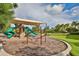 Outdoor playground with covered area, slides, climbing structures, and room to run at 11909 Climbing Fern Ave, Riverview, FL 33579
