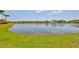 Scenic view of a large pond surrounded by well-maintained lawns and residences in a quiet community at 11909 Climbing Fern Ave, Riverview, FL 33579
