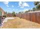 Large backyard with a wooden fence, offering privacy and space for outdoor activities at 1227 Tuxford Dr, Brandon, FL 33511