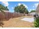 Fenced backyard featuring a concrete patio and trees providing shade at 1227 Tuxford Dr, Brandon, FL 33511