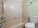 Standard bathroom featuring a bathtub, tiled walls, and a toilet at 1227 Tuxford Dr, Brandon, FL 33511