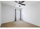 Bright bedroom with neutral carpet, ceiling fan, and a window with decorative curtains at 1227 Tuxford Dr, Brandon, FL 33511