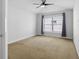 Spacious bedroom featuring neutral carpet, ceiling fan, and a bright window providing natural light at 1227 Tuxford Dr, Brandon, FL 33511