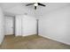 Bright bedroom with neutral carpet, featuring a ceiling fan and multiple doors for easy access at 1227 Tuxford Dr, Brandon, FL 33511