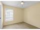 Cozy bedroom with neutral carpet and a bright window allowing natural light at 1227 Tuxford Dr, Brandon, FL 33511