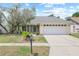 Charming single-Gathering home with well-maintained lawn, stone accents, and a two-car garage at 1227 Tuxford Dr, Brandon, FL 33511