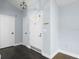 Clean, bright foyer with light blue walls, dark floors, and a white front door with glass panels at 1227 Tuxford Dr, Brandon, FL 33511
