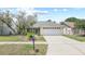 Traditional home with neutral paint, landscaping and a two car garage at 1227 Tuxford Dr, Brandon, FL 33511