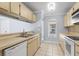 Bright kitchen has light cabinets, tile floors, and stainless steel sink at 1227 Tuxford Dr, Brandon, FL 33511