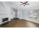 Spacious living room features wood floors, a fireplace, and a large window offering ample natural light at 1227 Tuxford Dr, Brandon, FL 33511