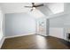 Bright living room with wood floors, vaulted ceiling, a fireplace, ceiling fan, and large windows at 1227 Tuxford Dr, Brandon, FL 33511