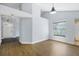 Open-concept living space with a front door view and wood floors, illuminated by a modern pendant light at 1227 Tuxford Dr, Brandon, FL 33511