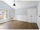 Bright, airy living room with wood floors, wainscoting, a window, and white-paneled doors at 1227 Tuxford Dr, Brandon, FL 33511