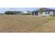 Expansive backyard offers ample space with views of adjacent homes, pond, and green space at 12572 Bergstrom Bay Dr, Riverview, FL 33579
