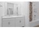 Bright bathroom with double sinks, white cabinetry, and a shower-tub combination at 12572 Bergstrom Bay Dr, Riverview, FL 33579
