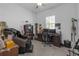 Comfortable bedroom featuring carpeted floors, ceiling fan, natural light, and dark furnishings at 12572 Bergstrom Bay Dr, Riverview, FL 33579