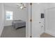 Bedroom and bathroom featuring a cozy bed, ceiling fan, and modern, glass-enclosed shower at 12572 Bergstrom Bay Dr, Riverview, FL 33579