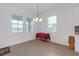 Dining room featuring three windows for ample lighting, wood-style floors and decorative chandelier at 12572 Bergstrom Bay Dr, Riverview, FL 33579