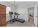 Bright exercise room features a treadmill, weights, and television for a complete fitness setup at 12572 Bergstrom Bay Dr, Riverview, FL 33579