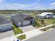 Well-maintained home with a two-car garage, landscaping, and view of a nearby recreation center at 12572 Bergstrom Bay Dr, Riverview, FL 33579
