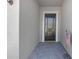 Inviting front porch with brick pavers leading to a black front door, and a welcoming flag at 12572 Bergstrom Bay Dr, Riverview, FL 33579