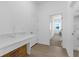 Clean laundry room with white countertop, storage, and a view to another room at 12572 Bergstrom Bay Dr, Riverview, FL 33579