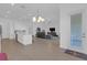 Open concept living room with wood-style floors, neutral tones, chandelier and plenty of natural light at 12572 Bergstrom Bay Dr, Riverview, FL 33579