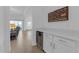 Elegant living room area with wet bar featuring under-counter fridge and access to the lanai at 12572 Bergstrom Bay Dr, Riverview, FL 33579