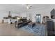Spacious living room with wood floors, a large sectional sofa and open view to the kitchen at 12572 Bergstrom Bay Dr, Riverview, FL 33579