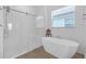 Bright bathroom with a glass-enclosed shower and luxurious soaking tub at 12572 Bergstrom Bay Dr, Riverview, FL 33579