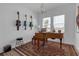 Music room with piano, guitars hanging on the wall, and a large area rug at 12572 Bergstrom Bay Dr, Riverview, FL 33579