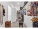 Bright walk-in closet includes custom organizers, shelves for shoes, and a convenient padded bench at 12572 Bergstrom Bay Dr, Riverview, FL 33579