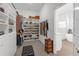 Spacious walk-in closet features custom shelving, shoe racks, and a view to the light and bright bathroom at 12572 Bergstrom Bay Dr, Riverview, FL 33579