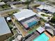 Aerial view of a home with a screened pool, patio and manicured grounds at 12965 Ridge Rd, Largo, FL 33778