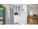 Well-lit kitchen with stainless steel appliances, modern cabinetry, and a comfortable adjacent seating area at 12965 Ridge Rd, Largo, FL 33778