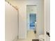 A bathroom with a shower featuring a shower curtain and a view of a bedroom at 13071 Willow Grove Dr, Riverview, FL 33579